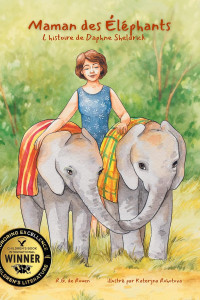 A woman smiles gently, walking between two baby elephants draped in colorful cloths. A "Children's Book Winner" seal is displayed. The tone is warm and nurturing.