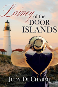 Title Lainey of the Door Islands. Lainey holding on to her hat as she gazes at the lighthouse.