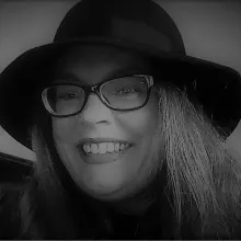 R. L. S. Hoff headshot. R. is wearing glasses and a hat.