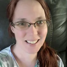 photo of author Molly Zenk. Red hair, glasses, smiling