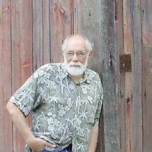 Leaning against the barn where Ernest Hemingway wrote portions of A Farewell to Arms in Piggott, Arkansas.
